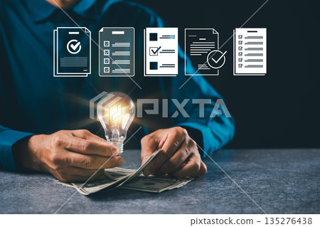 Businessman holding glowing bulb idea light business innovation solution growth marketing concept management leadership knowledge showing global financial success with checklist icons 135276438