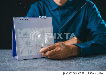 Creative job search light bulb career hire recruitment concept shows person holding glass bulb for employment opportunity near calendar, planning contemporary business success Creative job search light bulb career hire recruitment concept shows person holding glass bulb for employment opportunity near calendar, planning contemporary business success 135276467