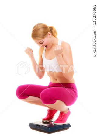 Happy successful woman weighing scale. Dieting. Happy successful woman weighing scale. Dieting. 135276662