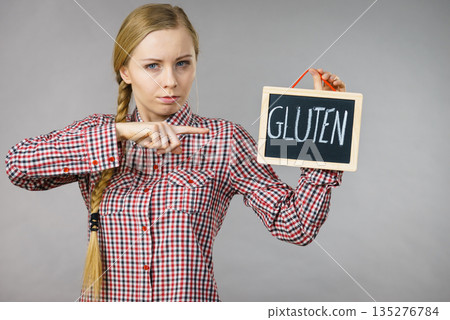 Woman holding board with gluten sign 135276784