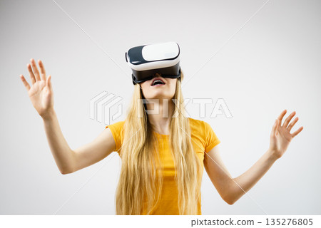 Girl wearing virtual reality goggles. 135276805