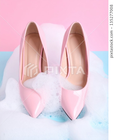 A pair of elegant pink ballet shoes and stylish high heels showcase a fusion of beauty and fashion in this closeup of sophisticated feminine footwear and accessory design 135277008