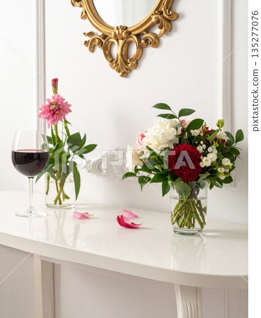 An elegant wedding reception table setting features a beautiful flower arrangement in a glass vase alongside candles and decor for a celebratory banquet dinner in a decorated restaurant room 135277076