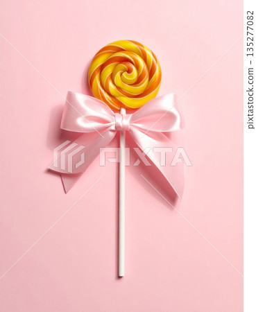 Festive red and pink lollipops and a candy cane isolated on white background decorated with a shiny satin ribbon bow for a Christmas holiday celebration gift or Valentine birthday present ornament 135277082