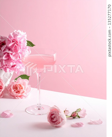 A delicate pink rose and petals in a glass cup create a sweet spring decoration for a wedding celebration or spa table 135277170