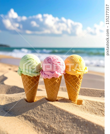 A delicious vanilla and strawberry frozen scoop in a wafer cone sits on the summer beach sand near the blue sea for a sweet cold dessert A delicious vanilla and strawberry frozen scoop in a wafer cone sits on the summer beach sand near the blue sea for a sweet cold dessert 135277357