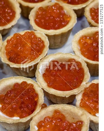 salmon caviar in tartlets, laid out on a festive table salmon caviar in tartlets, laid out on a festive table 135277525