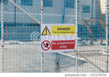 Danger Warning Sign on Construction Site Safety Fence 135278556
