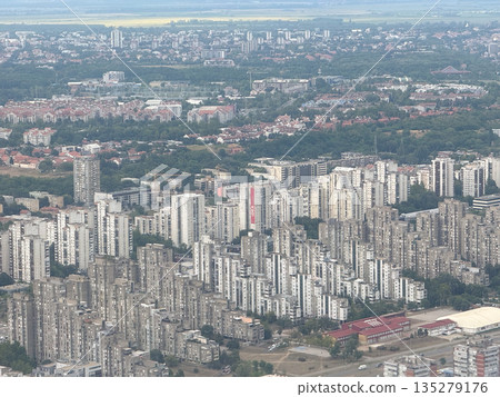 Aerial view of Belgrade residential districts and urban skyline from airplane. City density, housing development, and metropolitan expansion through infrastructure, population, and planning Aerial view of Belgrade residential districts and urban skyline from airplane. City density, housing development, and metropolitan expansion through infrastructure, population, and planning 135279176