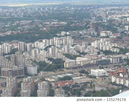 Aerial view of Belgrade residential districts and urban skyline from airplane. City density, housing development, and metropolitan expansion through infrastructure, population, and planning 135279178