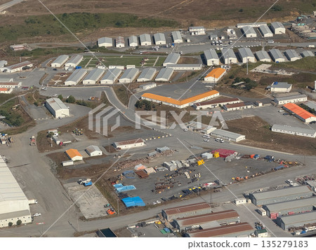 Industrial airport service zone seen from above. Logistics facilities, operational planning, and transport infrastructure through aerial perspective 135279183