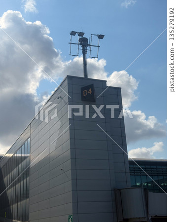 Airport terminal building with gate D4 sign. Travel navigation, passenger orientation, and transport infrastructure through modern architecture 135279192