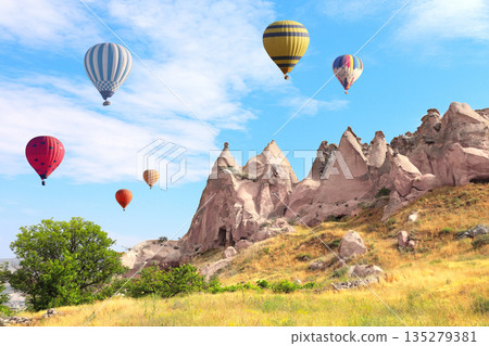 Balloon flight, famous tourist attraction of Cappadocia. Air balloons and Fairy Chimney in Pasabag Valley, Anatolia, Turkey. Topic of vacation, travel, trip abroad on vacation, cruises and tours Balloon flight, famous tourist attraction of Cappadocia. Air balloons and Fairy Chimney in Pasabag Valley, Anatolia, Turkey. Topic of vacation, travel, trip abroad on vacation, cruises and tours 135279381