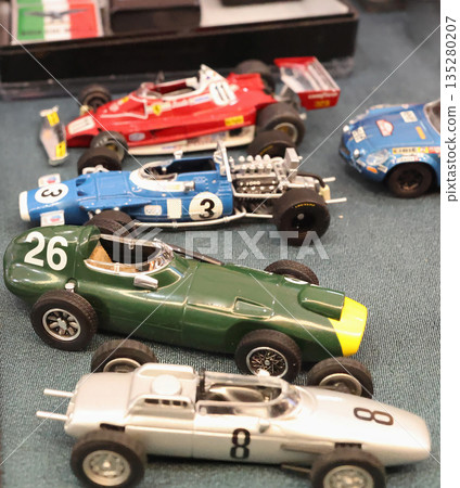 Flea antique market in Europe, Italy. Old vintage items. Toys, car, transport on tables in town. Retro objects for background design. Flea antique market in Europe, Italy. Old vintage items. Toys, car, transport on tables in town. Retro objects for background design. 135280207