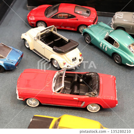 Flea antique market in Europe, Italy. Old vintage items. Toys, car, transport on tables in town. Retro objects for background design. Flea antique market in Europe, Italy. Old vintage items. Toys, car, transport on tables in town. Retro objects for background design. 135280210