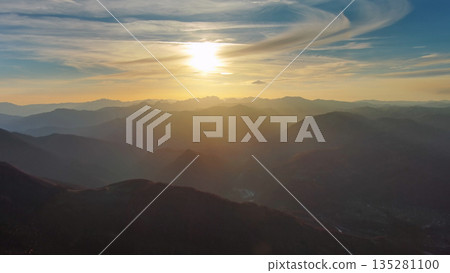 Flying over colorful foliage at sunset in mountains Flying over colorful foliage at sunset in mountains 135281100