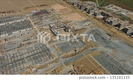 Industrial construction site with construction equipment and materials 135281135