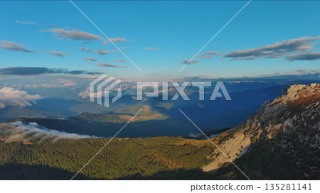 Aerial view of amazing rocky mountains at sunset Aerial view of amazing rocky mountains at sunset 135281141