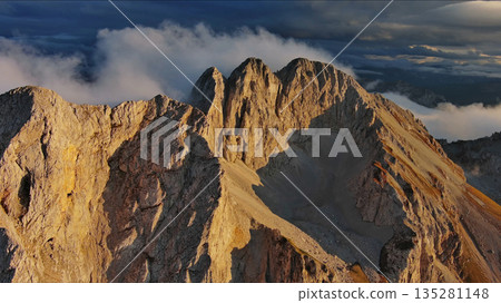 Amazing rocky mountains in clouds at sunset 135281148