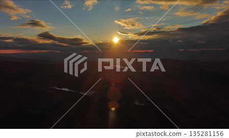 Amazing rocky mountains and sun at sunset Amazing rocky mountains and sun at sunset 135281156