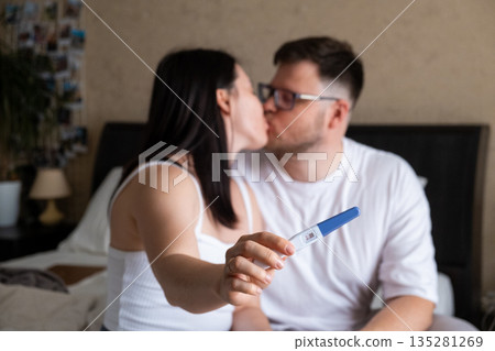 Happy Couple Celebrating Positive Pregnancy Test 135281269