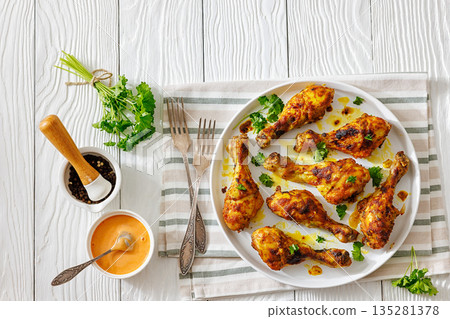roasted chicken drumsticks on a white plate 135281378