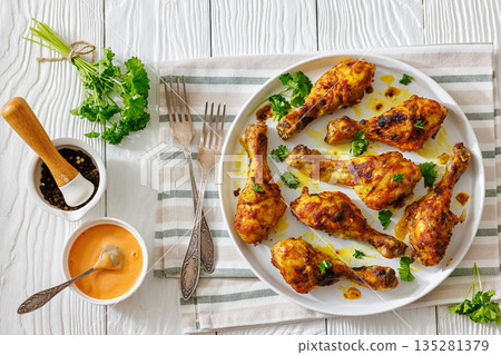 roasted chicken drumsticks on a white plate roasted chicken drumsticks on a white plate 135281379
