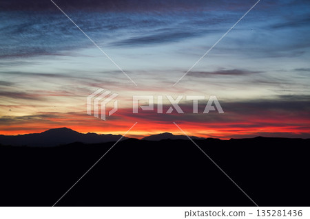 Smooth Gradient Sunset Sky With Soft Clouds Above Calm Mountain Horizon Creating Peaceful Nature Background Smooth Gradient Sunset Sky With Soft Clouds Above Calm Mountain Horizon Creating Peaceful Nature Background 135281436