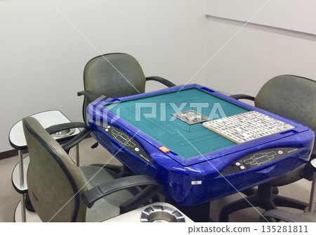 A blue, fully automatic mahjong table in a mahjong parlor 135281811