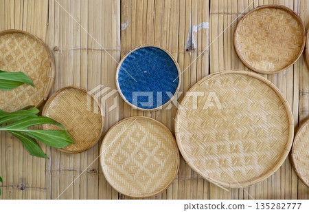 Woven Rattan Baskets on Bamboo Background with Blue Basket 135282777