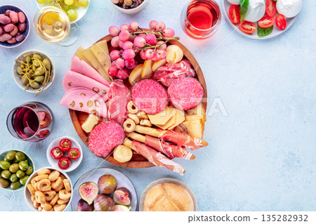 Italian Antipasti. Charcuterie platter with cheese and other snacks, with wine 135282932