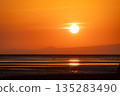 Sunset over the ocean at low tide 135283490