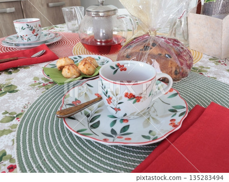Table setting with bright tableware, berries, and twigs. Italian ceramic tableware. Teacup on saucer with traditional pie. Aesthetics and lifestyle. Interior design. Table setting with bright tableware, berries, and twigs. Italian ceramic tableware. Teacup on saucer with traditional pie. Aesthetics and lifestyle. Interior design. 135283494
