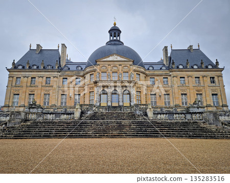 Maincy, France - December 11, 2025: Backyard facade view of Chateau de Vaux-le-Vicomte. Beautiful Baroque architecture with grand dome, and decorated with classical statues and antique stone steps Maincy, France - December 11, 2025: Backyard facade view of Chateau de Vaux-le-Vicomte. Beautiful Baroque architecture with grand dome, and decorated with classical statues and antique stone steps 135283516