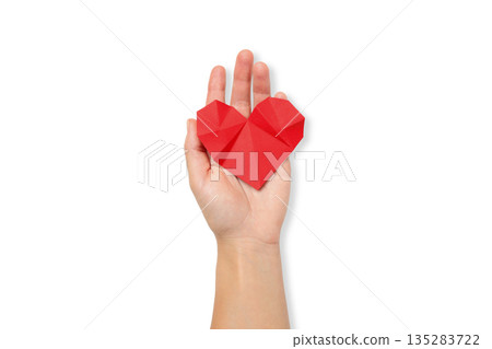 Hand holds a red origami heart for donation campaign, isolated, PNG 135283722