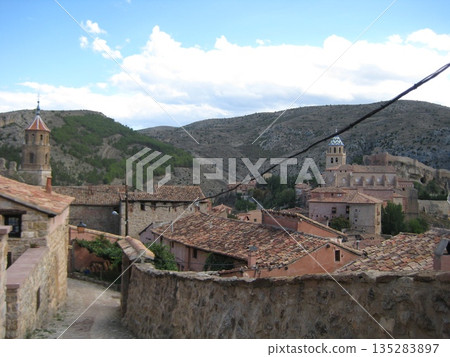 A narrow street overlooking the rooftops of Albarracín A narrow street overlooking the rooftops of Albarracín 135283897