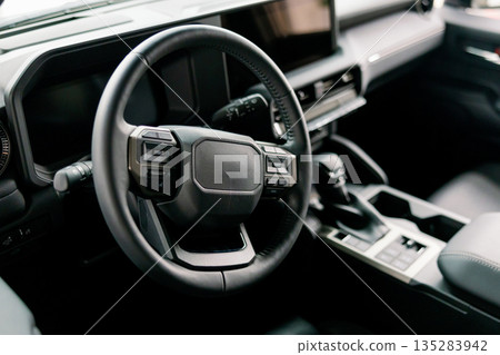 Modern Car Interior Showing Steering Wheel, Dashboard, and Leather Seats Modern Car Interior Showing Steering Wheel, Dashboard, and Leather Seats 135283942