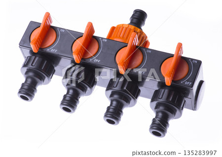 Plastic 4-channel distributor to supply water on a white background Plastic 4-channel distributor to supply water on a white background 135283997
