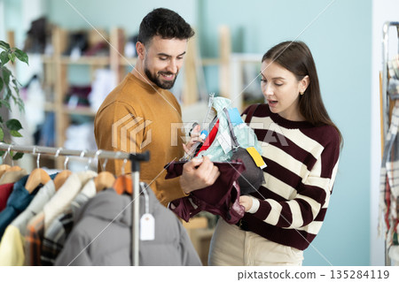 Couple choosing lingerie in a European store Couple choosing lingerie in a European store 135284119