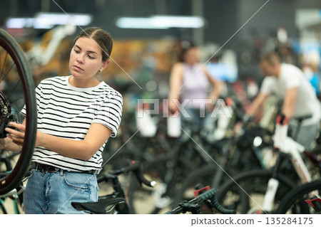 Young woman choosing bike in store 135284175