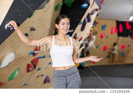 Young woman posing near climbing wall 135284209