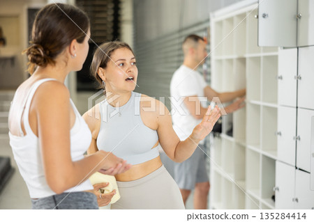 Young women exchanged couple of phrases in ladies locker room after changing clothes Young women exchanged couple of phrases in ladies locker room after changing clothes 135284414