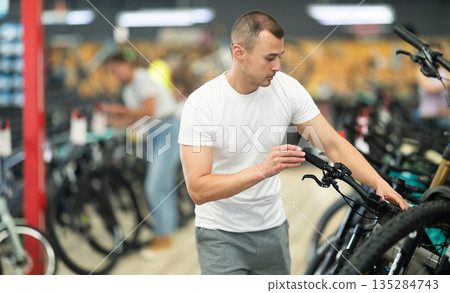 Young man choosing bike in store 135284743