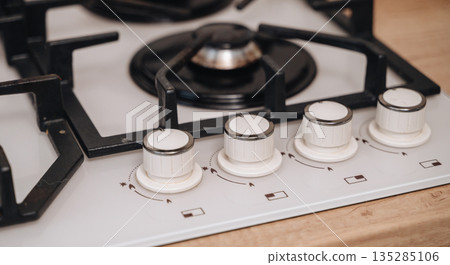 Gas stove with range hood in bright modern kitchen interior Gas stove with range hood in bright modern kitchen interior 135285106