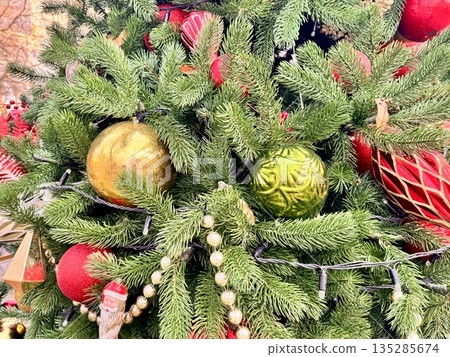 a beautiful Christmas tree decorated with Christmas balls and toys 135285674