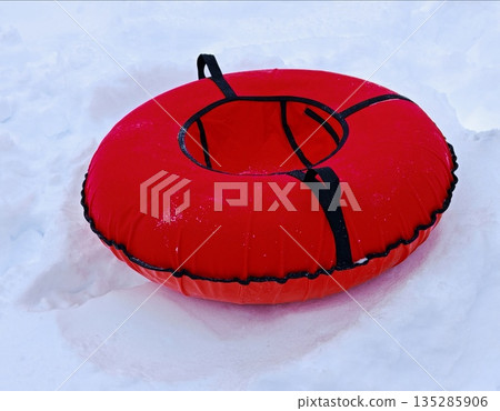 tubbing on the snow. winter activities, skiing. red Snow tubing in the snow outdoors. tubbing on the snow. winter activities, skiing. red Snow tubing in the snow outdoors. 135285906