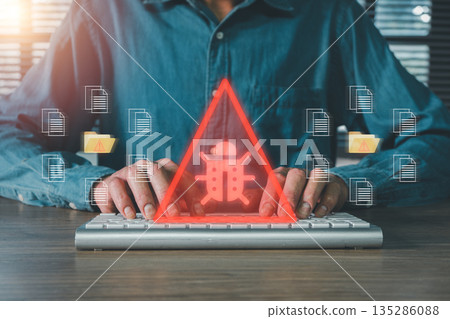 Person typing on keyboard with digital bug warning symbol, representing cybersecurity threats and data protection. Person typing on keyboard with digital bug warning symbol, representing cybersecurity threats and data protection. 135286088