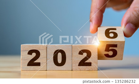 Hand Changing Year From 2025 to 2026 on Wooden Blocks Display Hand Changing Year From 2025 to 2026 on Wooden Blocks Display 135286232