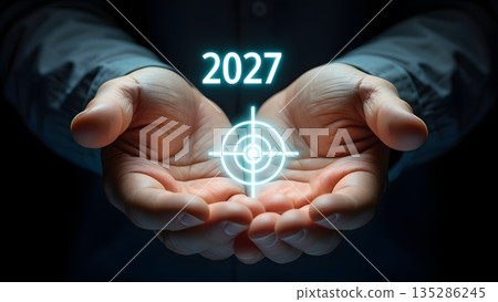 Future Vision: Hands Holding Target Symbol with Year 2027 Light 135286245