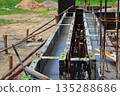 Newly poured concrete foundation beams at the construction site with steel bar reinforcement. 135288686